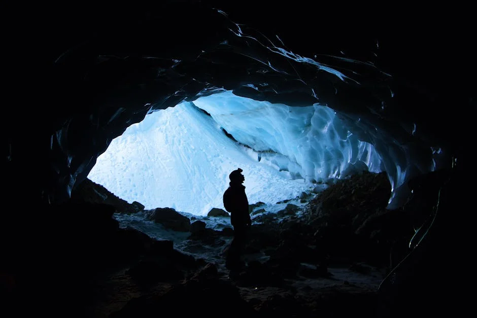 Apostle Islands ice caves interior with dramatic frozen formations and visitor silhouette