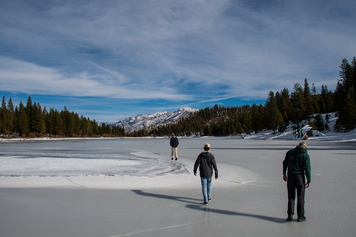 Group snowshoeing on Bear Lake snowshoe trails Rocky Mountain National Park with mountain backdrop