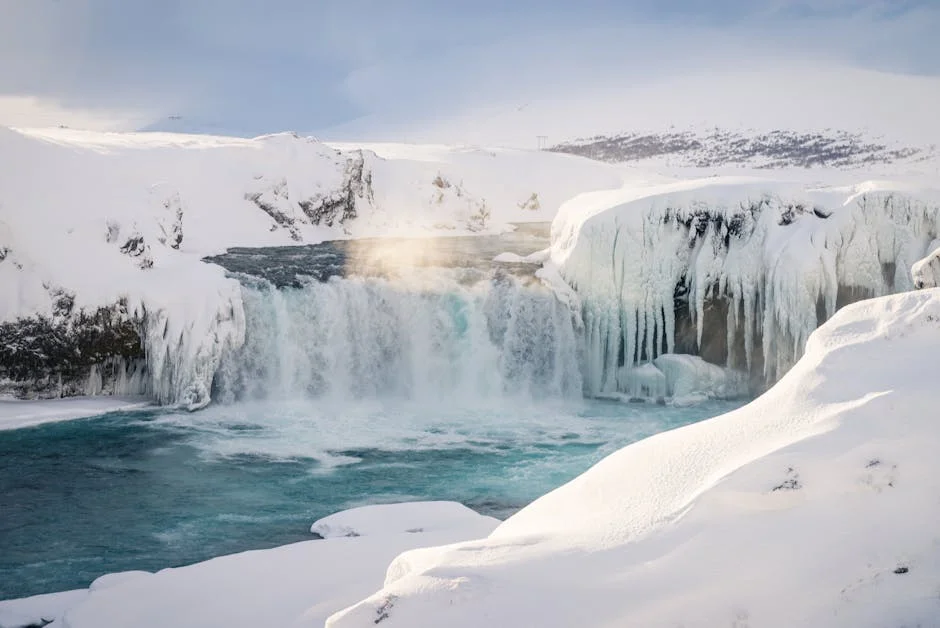 Tahquamenon Falls Winter Hiking Guide (2026) 2 Frozen waterfall surrounded by snow and ice in Michigan's Upper Peninsula