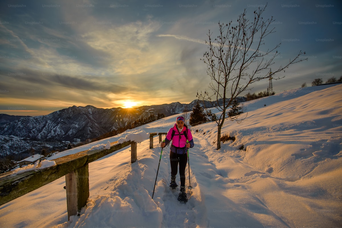 Solo snowshoer on a sunset winter hike through Rocky Mountain National Park