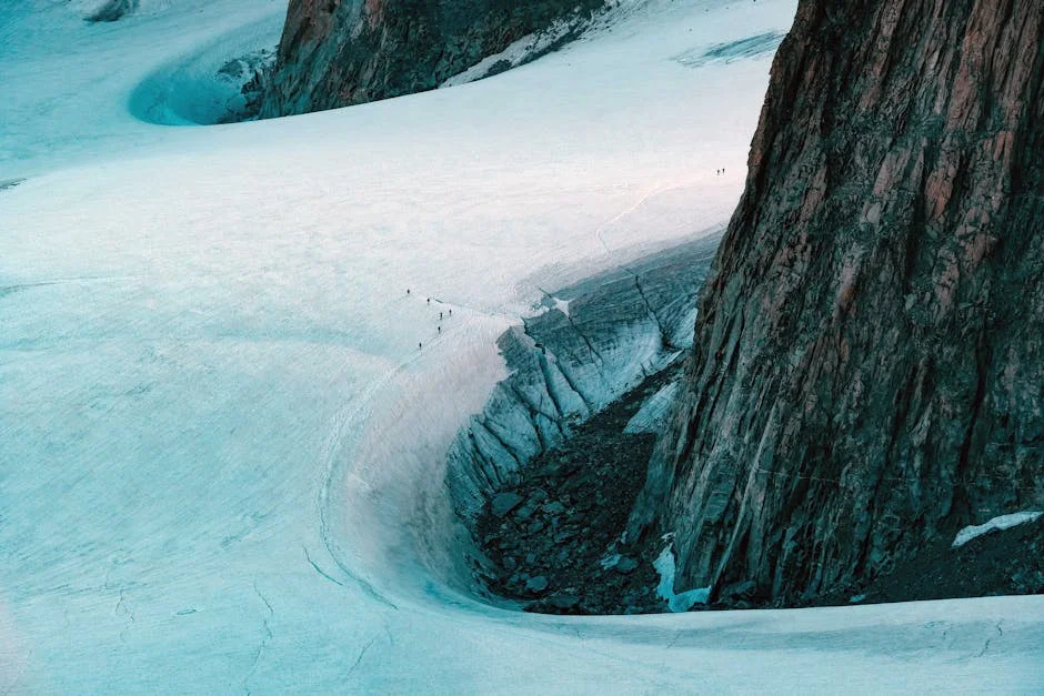 Aerial view of hikers traversing snowy mountain trail showing winter terrain challenges