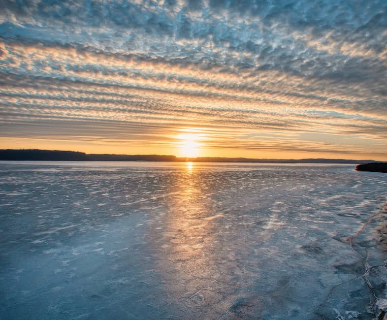 Sunset over frozen Lake Superior in Wisconsin with dramatic ice reflections