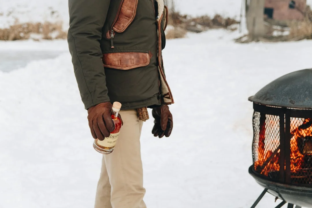 Hypothermia Prevention: What Every Hiker Needs to Know at Highline Trail 6 Hiker warming up next to campfire in snowy backcountry demonstrating emergency heat technique