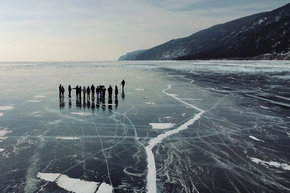 Aerial view of people walking on frozen Lake Superior showing scale of Apostle Islands winter landscape