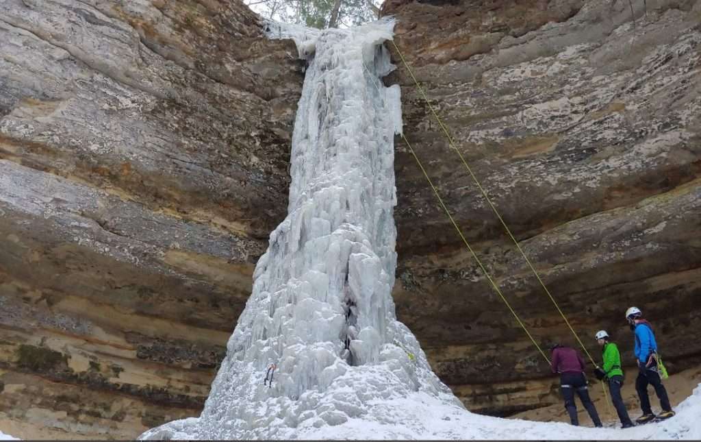 Pictured Rocks Snowshoeing January: Ice Caves Guide (2026) 5 Ice climbers scaling frozen ice formations at Pictured Rocks National Lakeshore
