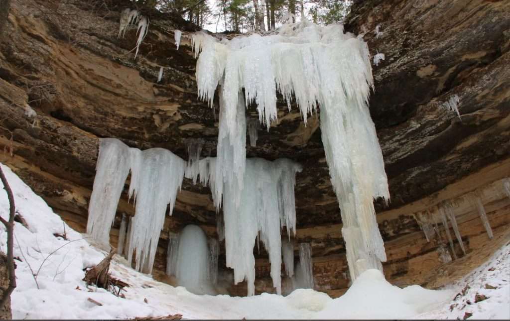 Pictured Rocks Snowshoeing January: Ice Caves Guide (2026) 2 Spectacular ice curtains formed along sandstone cliffs at Pictured Rocks in winter