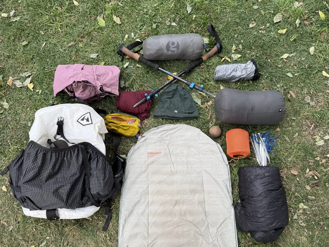 Winter camping scene with snow-covered tent and surrounding forest