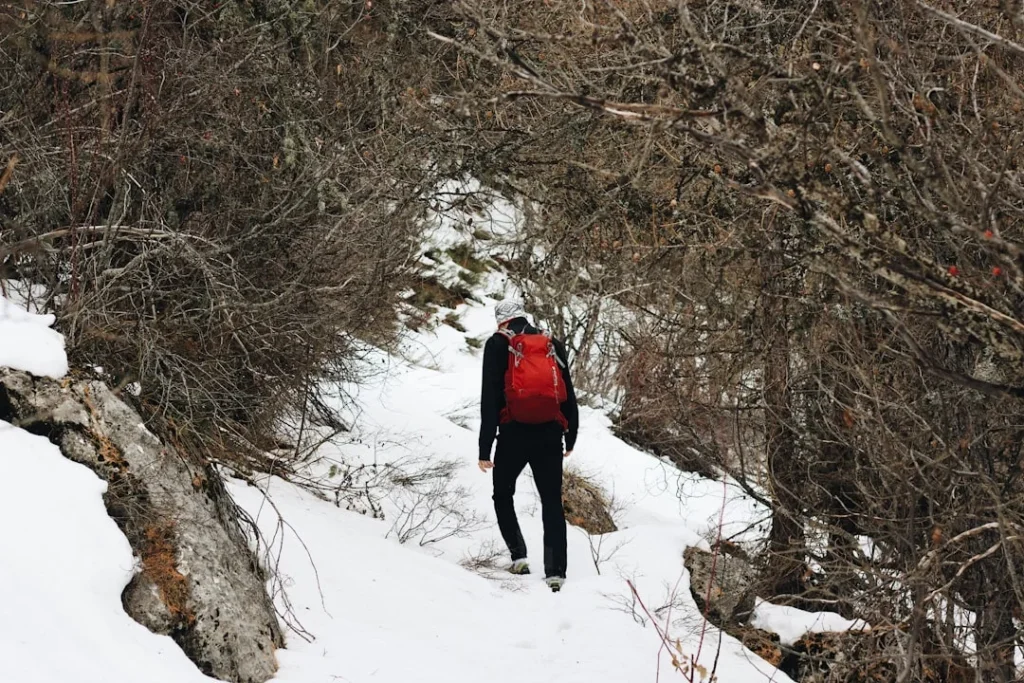 Pacific Crest Trail winter hiking safety - hiker with backpack on snowy terrain