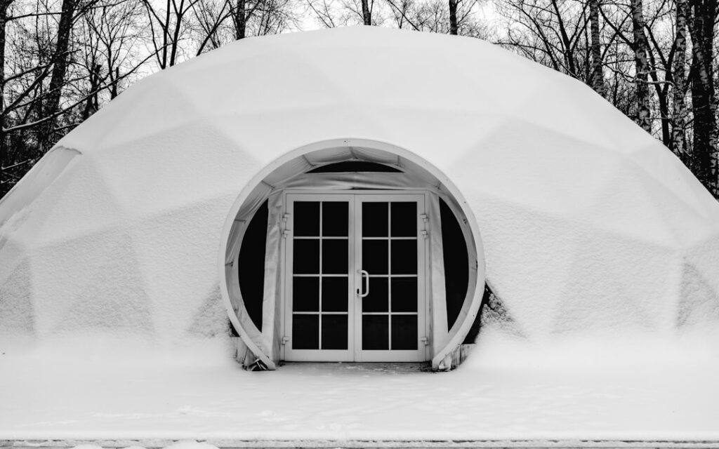 Emergency winter shelter building in the Boundary Waters - quinzhee snow shelter in a boreal forest clearing