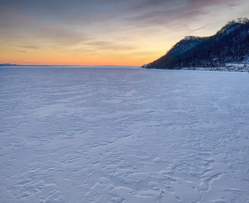 Frozen Minnesota lake at winter sunset with expansive ice and sky