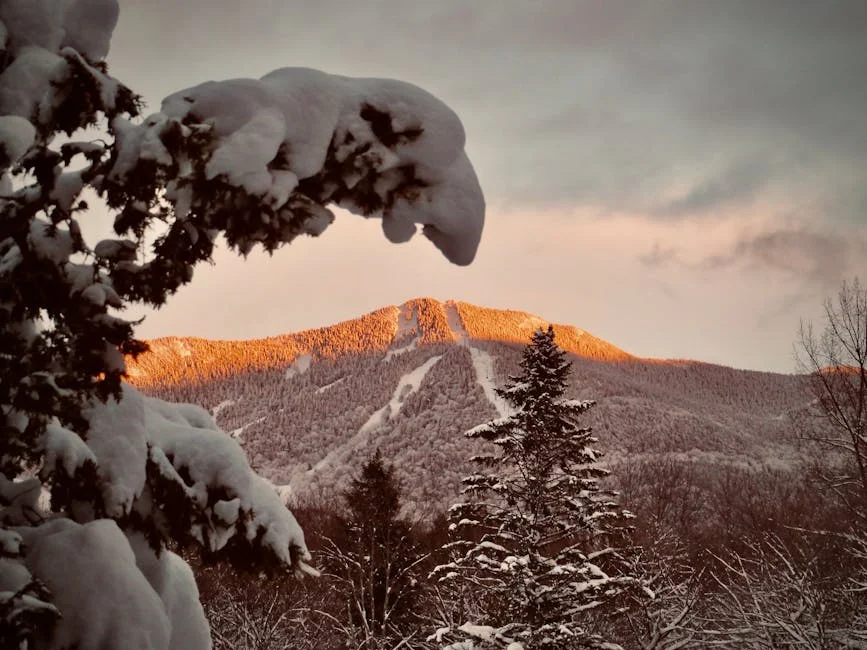 Breathtaking winter landscape of snow-covered mountains at sunset in Vermont