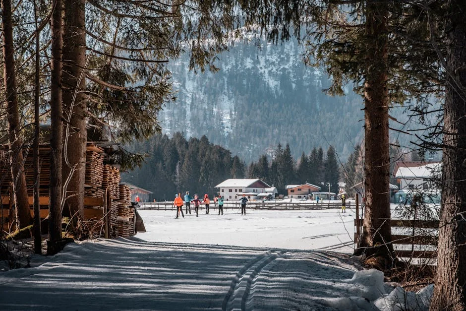 Cross country skiing through snowy forest with tall trees and mountain chalets