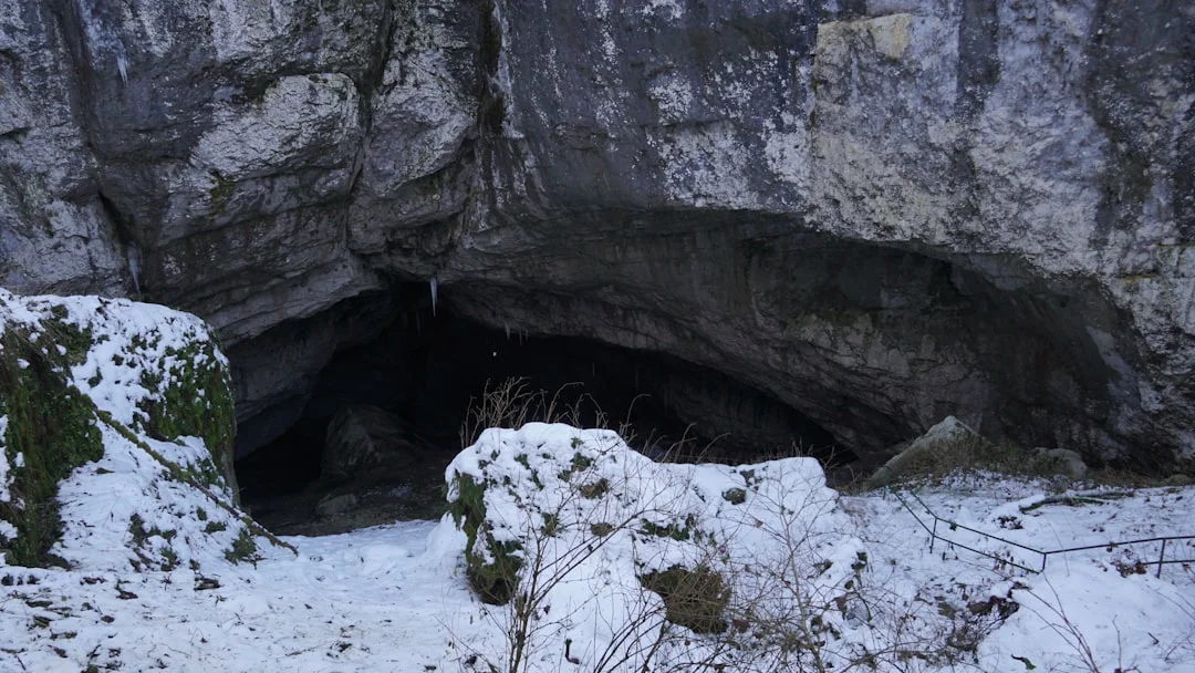 Snow cave entrance showing thick snow walls and the insulation depth of a winter shelter