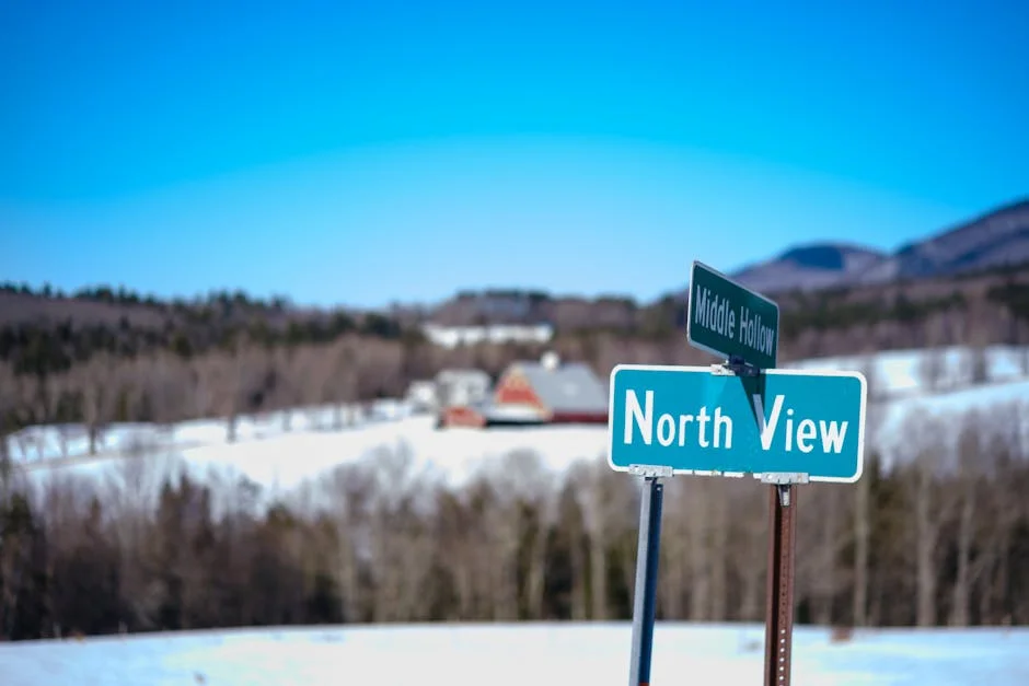 Scenic winter landscape featuring rural farmland and snow-covered roads in Vermont