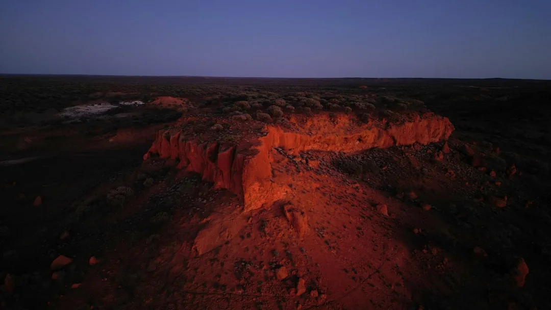 Canyon rim edge illuminated by golden twilight on Red Canyon Trail