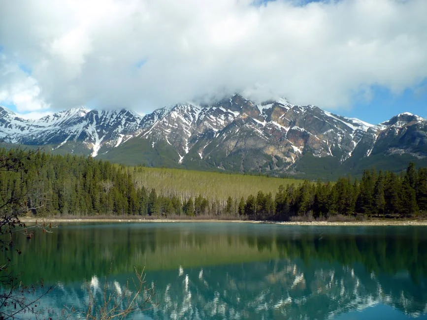 Stunning view of a pristine mountain lake with perfect reflections of surrounding peaks