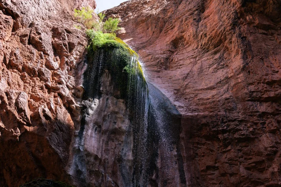Ribbon waterfall cascading down Grand Canyon rock face during spring rain